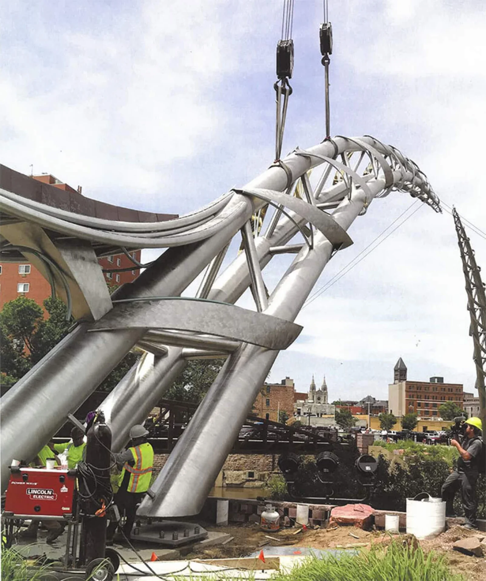 Monumental public sculpture undergoing professional crane installation and engineered large-scale metal fabrication for civic, hospitality, and mixed-use development environments.